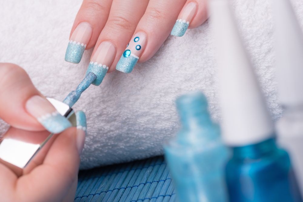 Applying Blue Nail Polish